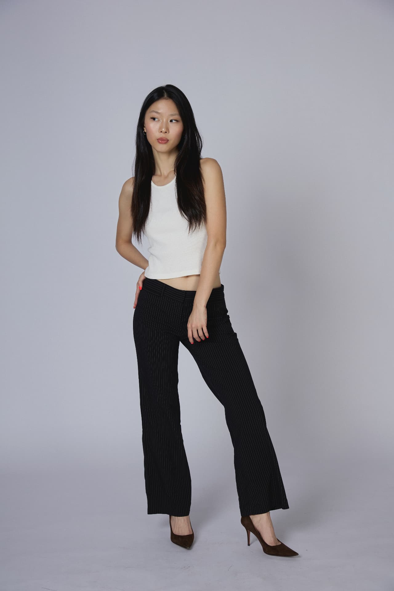 Minshan standing in a studio, full-length portrait